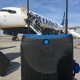 Jurni suitcase next to a Ryanair plane