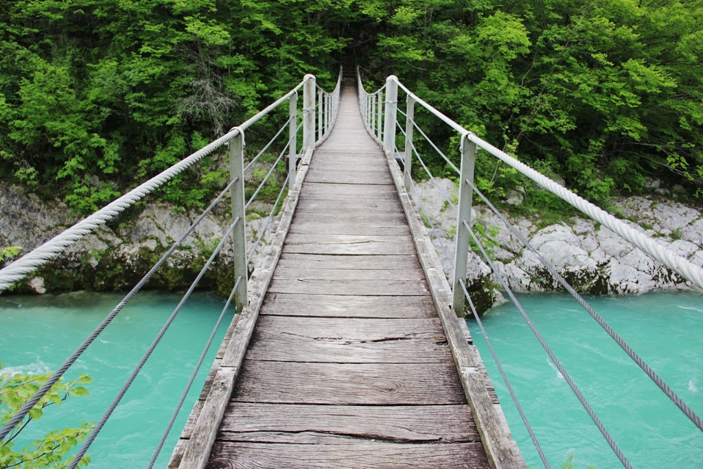 Crossing a suspension bridge over the Soca River - Slovenia