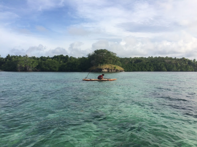 A local man stops for a quick fish before kayaking around the coast