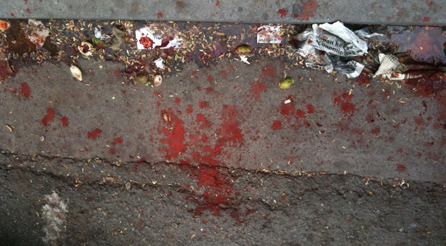 Red betel nut remnants on a road in Papua New Guinea