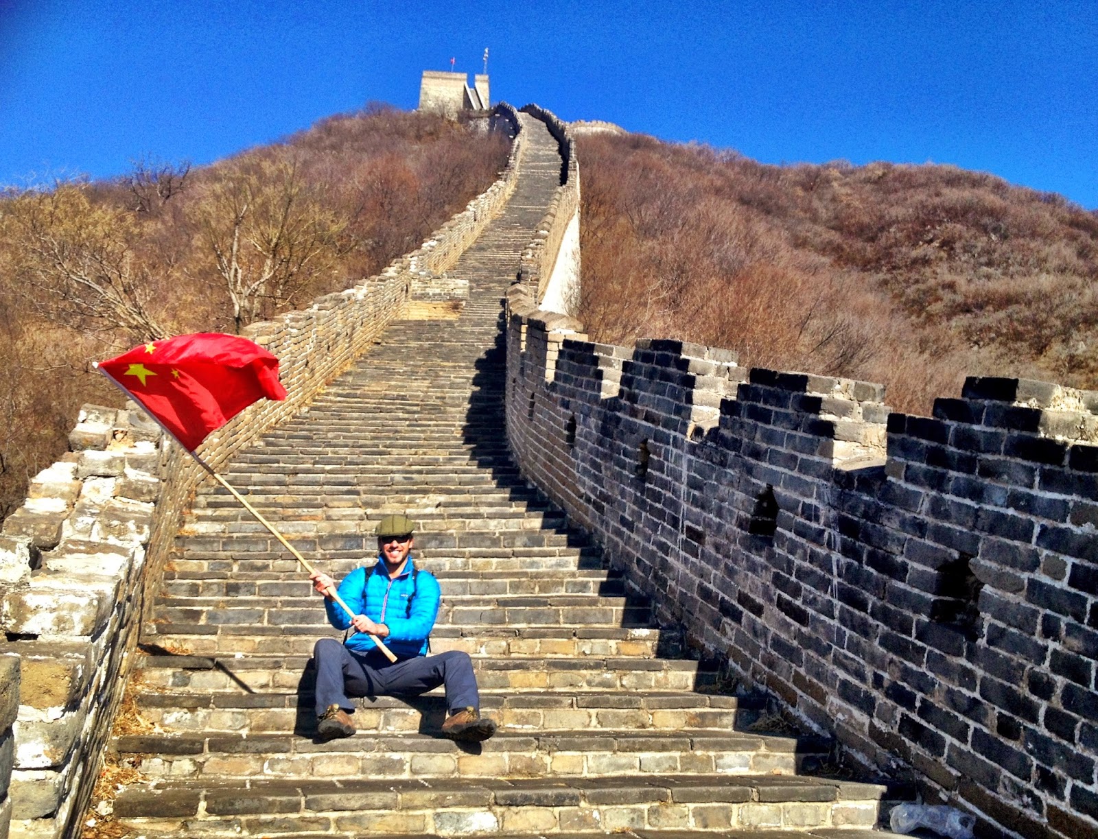 Simon waving a Chinese flag on the Great Wall