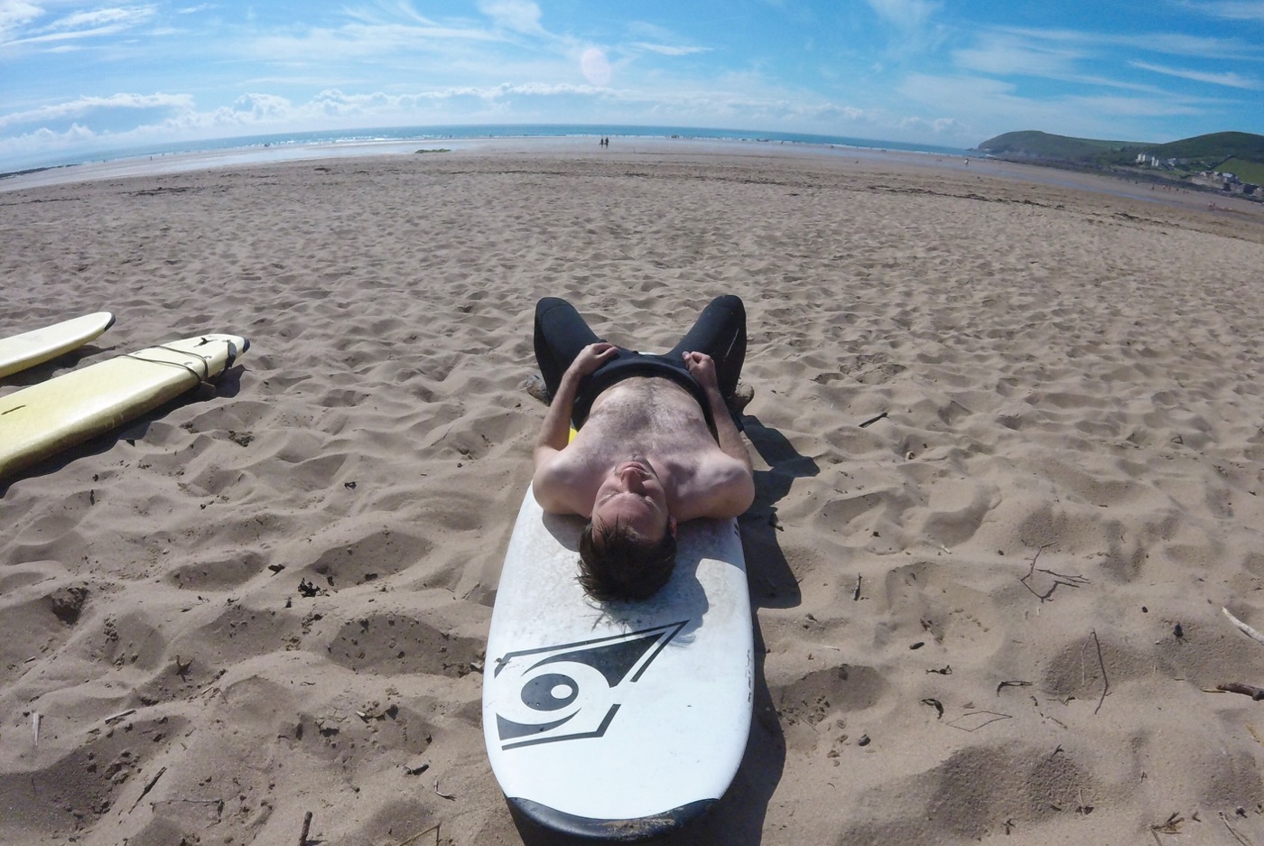 Simon having a post-surf nap on Croyde beach, Devon