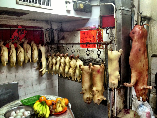 Pigs hanging waiting to be cooked in a steel oven - Hong Kong