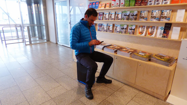 Simon Heyes sitting on a Jurni case at the airport - MyJurni