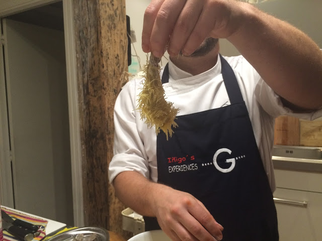 Chef Íñigo with an urchin prawn - Tenedor tours cooking class - San Sebastian